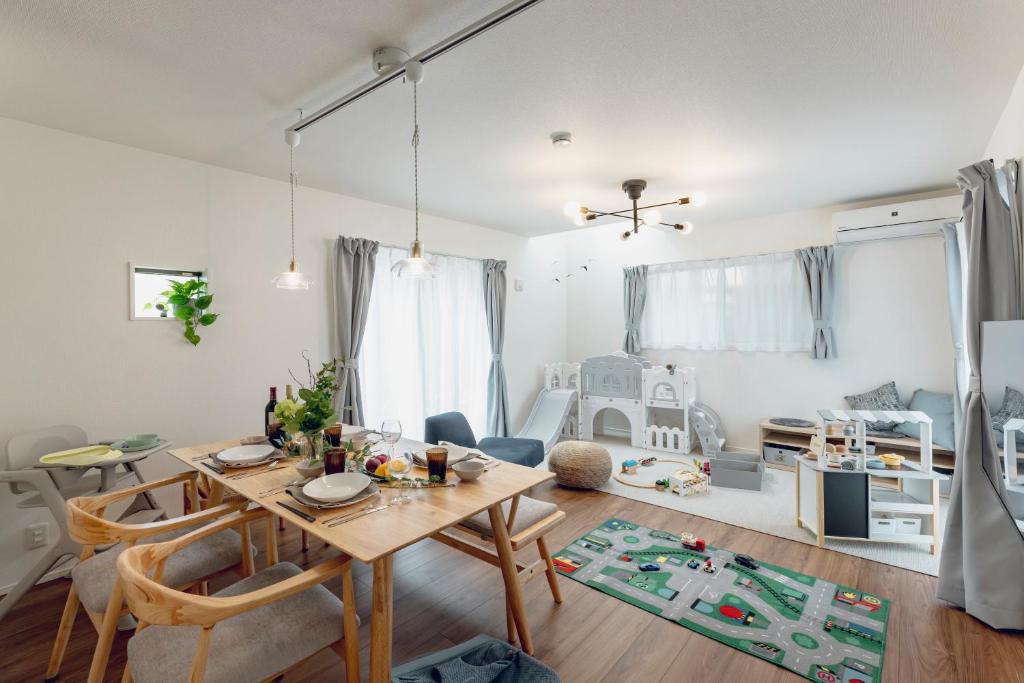 a living room with a dining table and a playroom at Sion MINATO in Nagoya