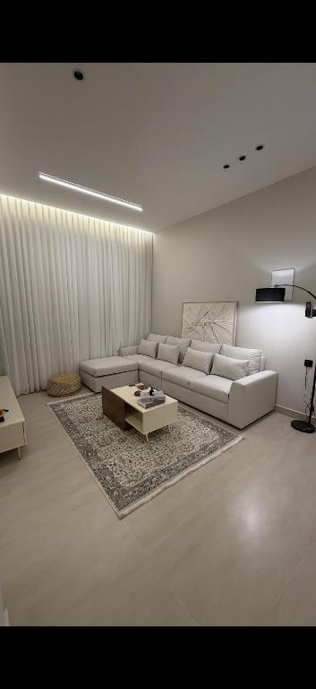 a living room with a couch and a coffee table at Elite stay 1 in Buraydah