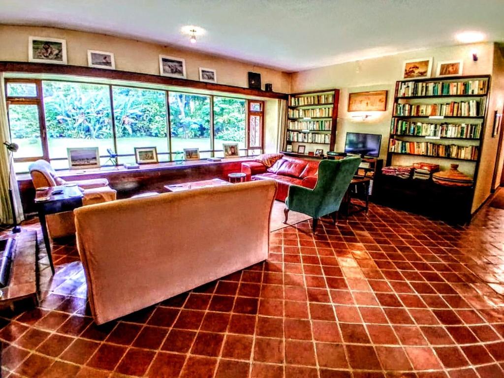 a living room with a couch and bookshelves at The Researchers Rest in Arusha