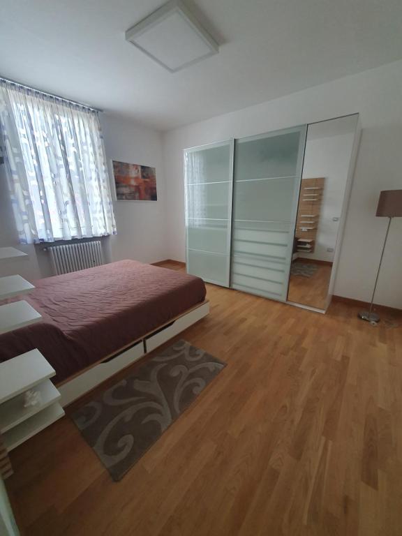a bedroom with a bed and a wooden floor at Casa Mane in Avezzano