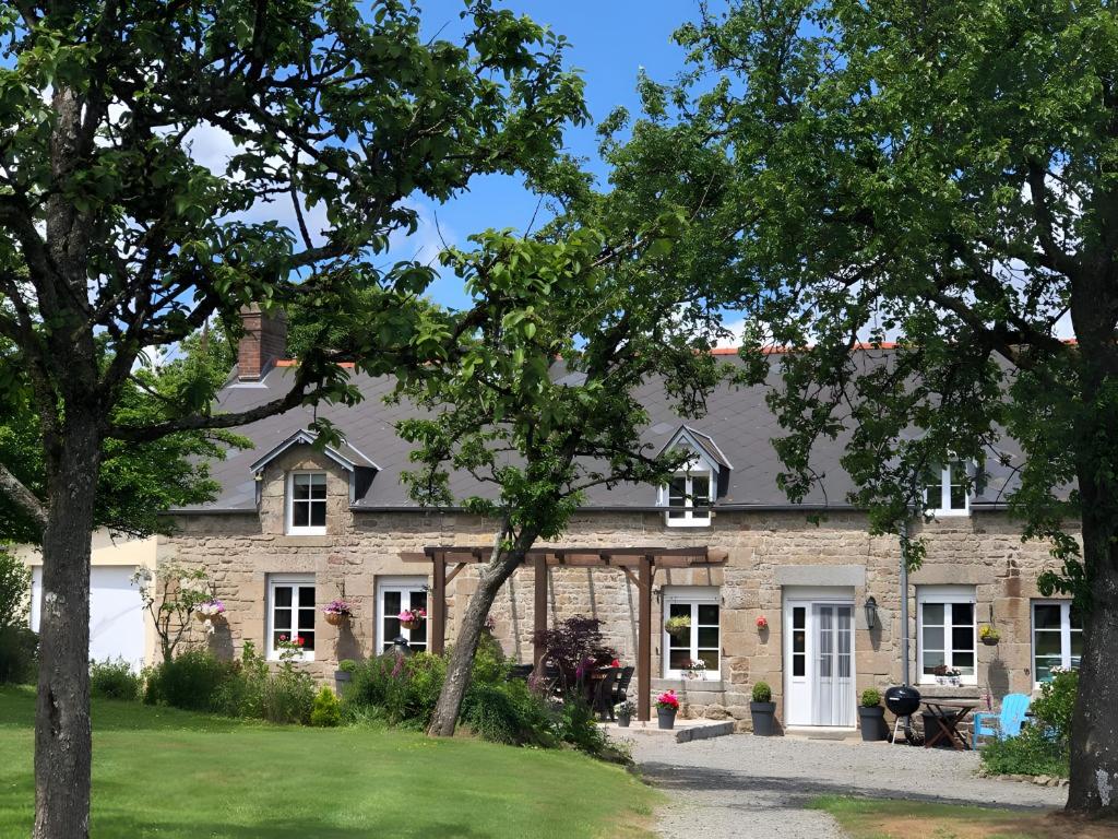 a stone house with trees in front of it at Hill Crest Gite in Vengeons