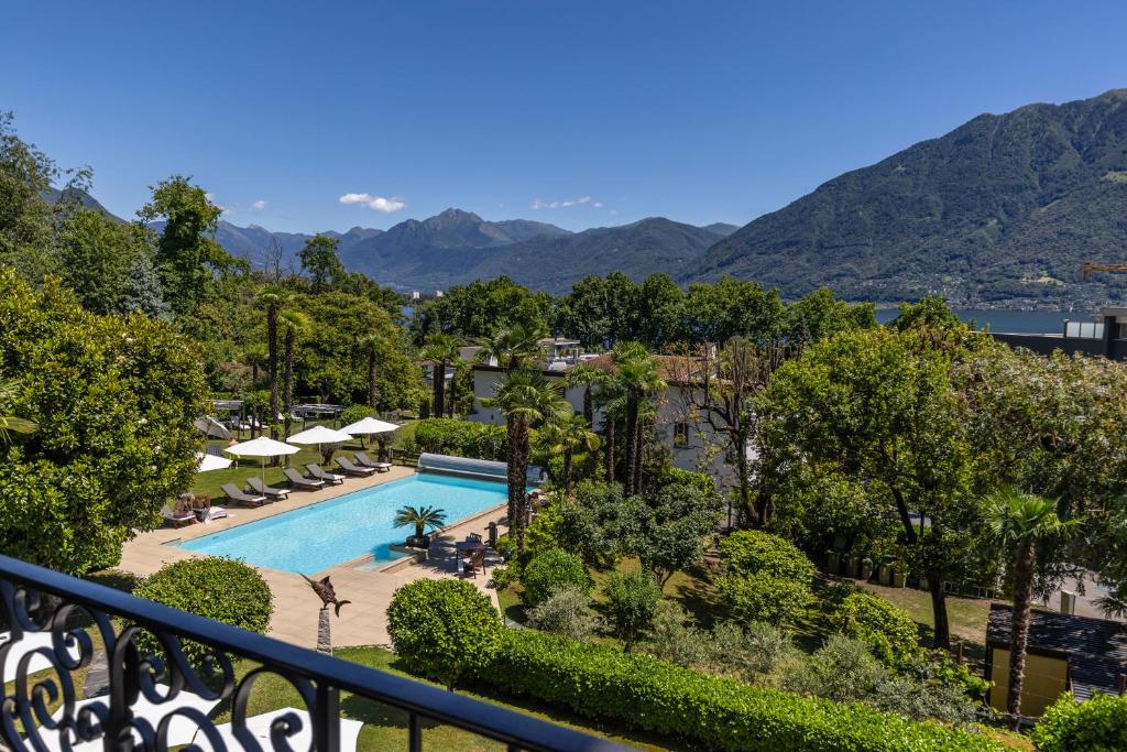 a view of the pool at a resort at Boutique-Hotel REMORINO, a Lago Maggiore GARDEN RESORT in Locarno