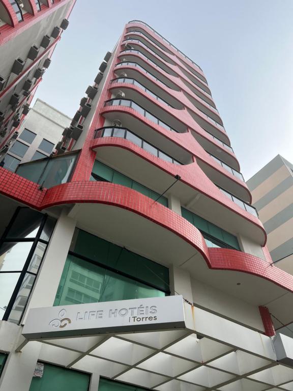 a high rise building with a life horizons hotel at Life Hotel Torres in Torres