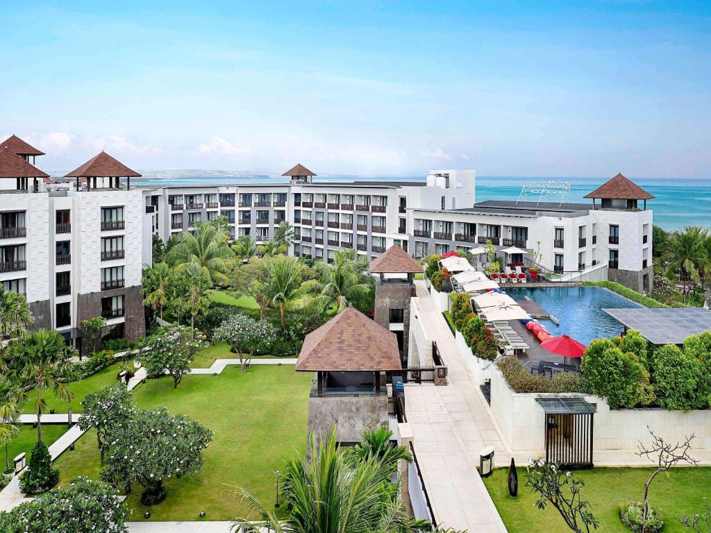 an aerial view of a resort with a swimming pool at Pullman Bali Legian Beach in Legian