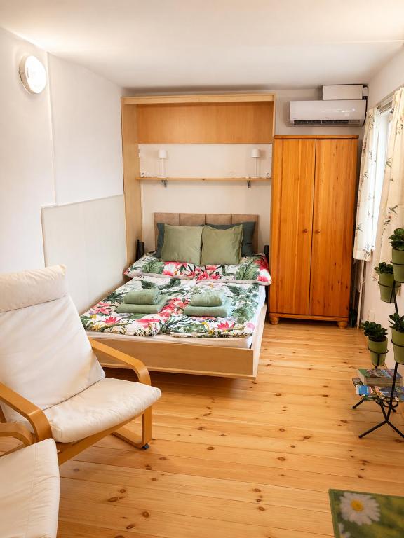 a bedroom with a bed and a chair in it at Cozy Studio in Szentendre