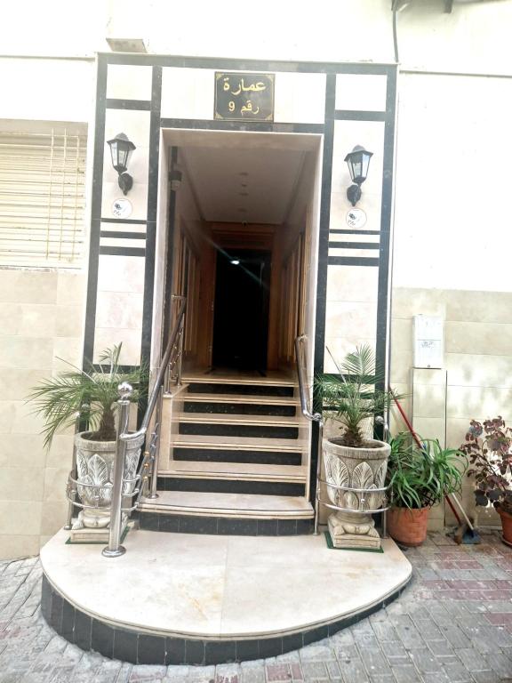 a staircase leading to a building with potted plants at la Casa de doha in Tangier