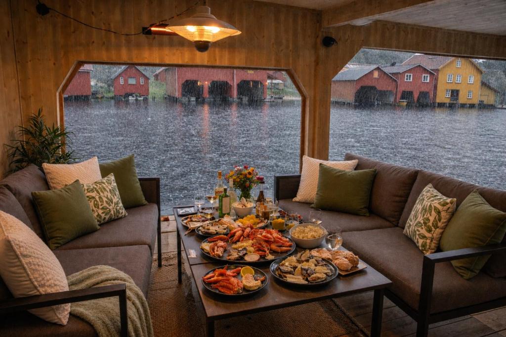 a table full of food on a couch in a house at Stunning 3-Bedroom Apartment at Feda Waterfront in Feda