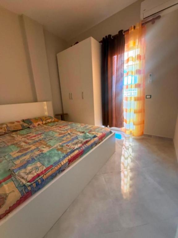 a bedroom with a bed in a room with a window at Casa Mare in Golem