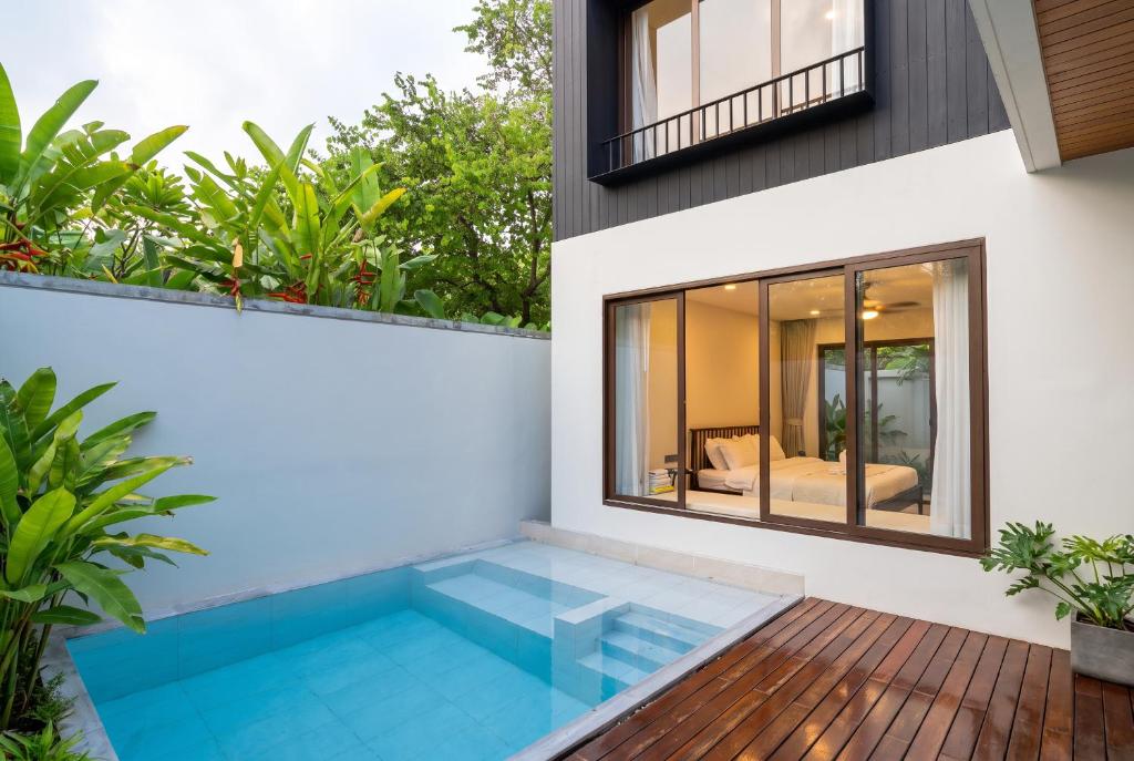 a swimming pool in the backyard of a house at Qabalah Villa Private Pool & Rooftop Garden Stylish 2BR Retreat near Bang Tao in Ban Pak Lak