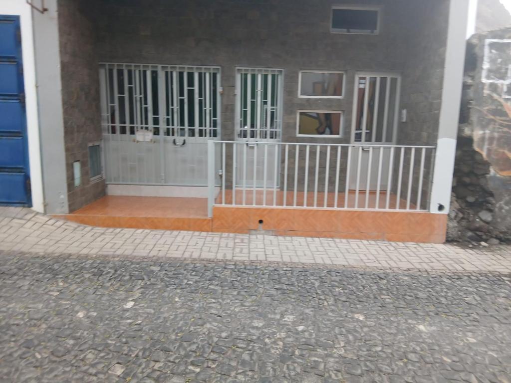 a building with two gates on the side of it at Salão Zuzu in Ribeira Grande