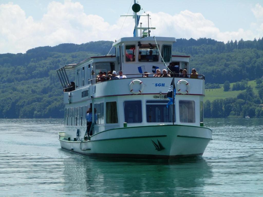 a boat on the water with people on it at Vitabella Rügel in Seengen