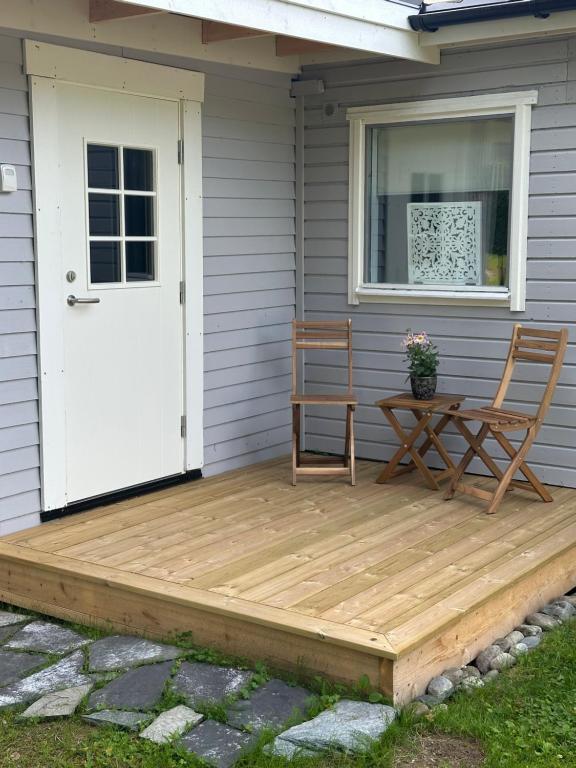 a wooden deck with a table and chairs on a house at Parkgatan in Vemdalen