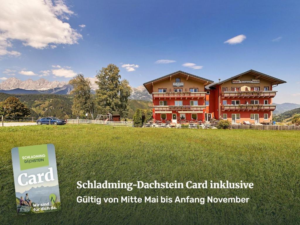 a large building with a sign in front of it at Hotel Pariente in Schladming