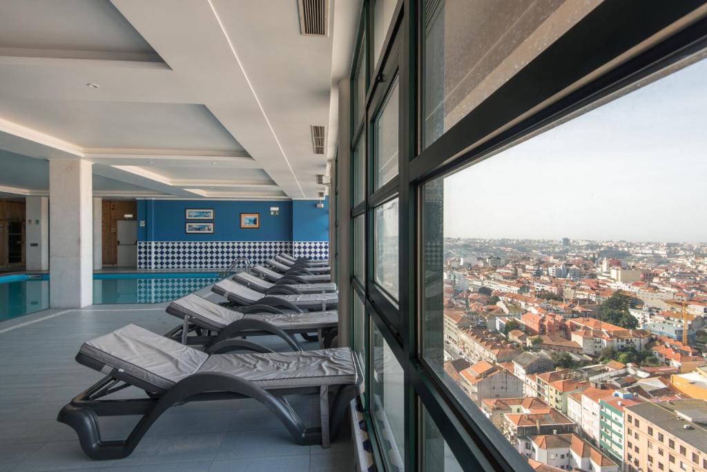 a row of lounge chairs on the balcony of a building at Vila Gale Porto - Centro in Porto