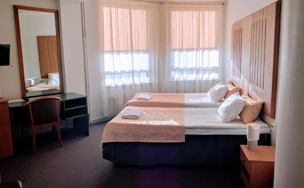 Voodi või voodid majutusasutuse Center Hotel toas