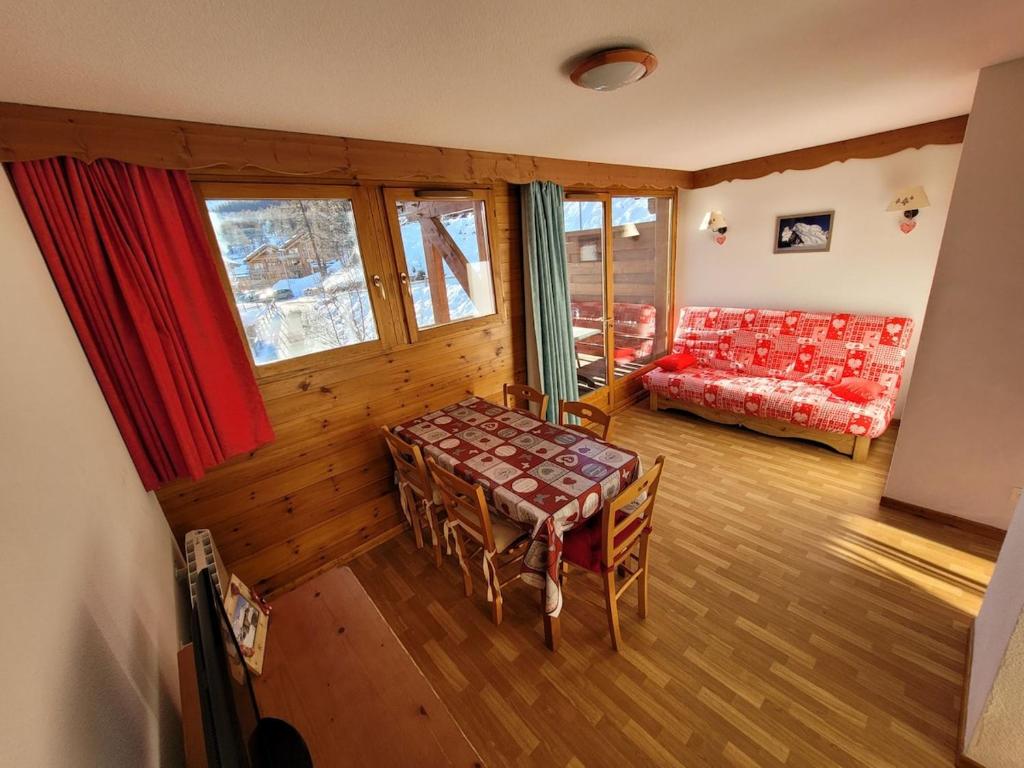 a living room with a table and a couch at Sunny chalettt great view ski in Puy-Saint-Vincent