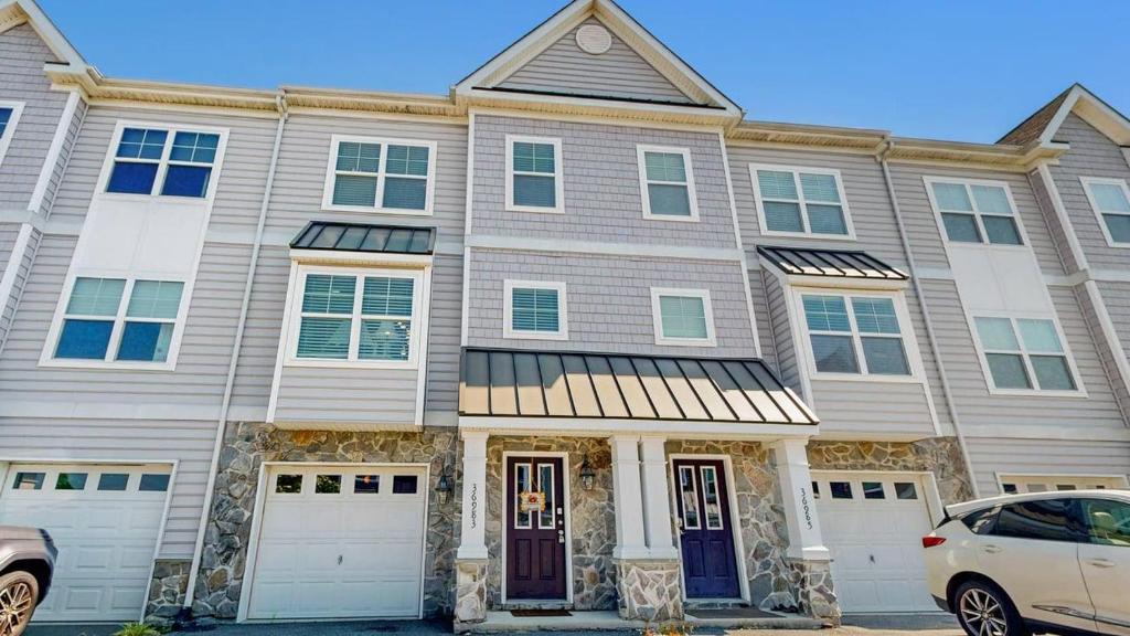 a large house with a car parked in front of it at Rehoboth Crossing - 36983 Grindstone Ln in Rehoboth Beach