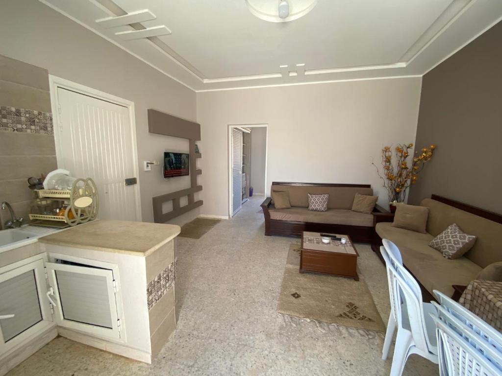 a living room with a couch and a table at Raies in Akouda