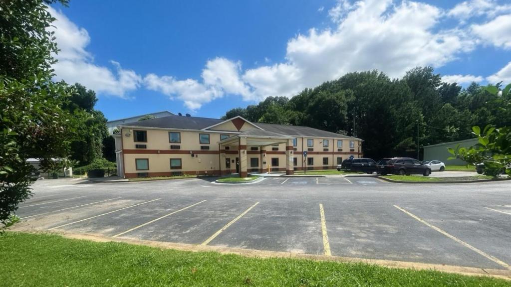 a building with a parking lot in front of it at Crown Inn in Carrollton