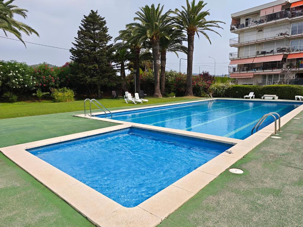 a large swimming pool in a yard with a building at Bonamar in Cabrera de Mar