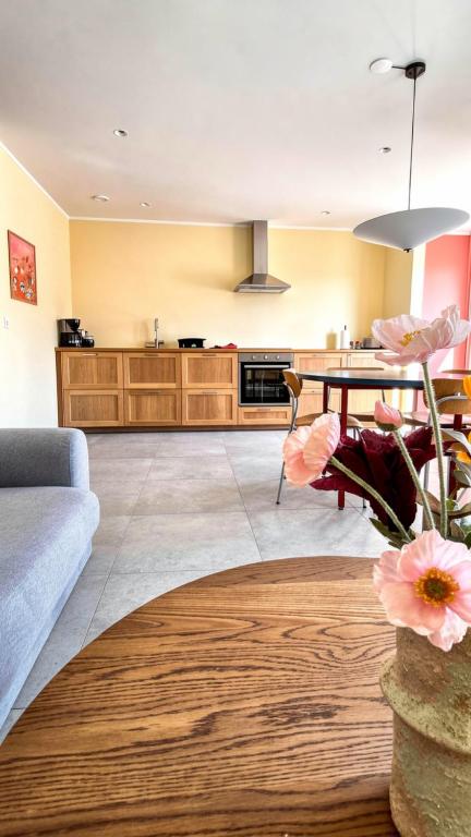 a living room with a couch and a table at Eldá apartments in Myvatn