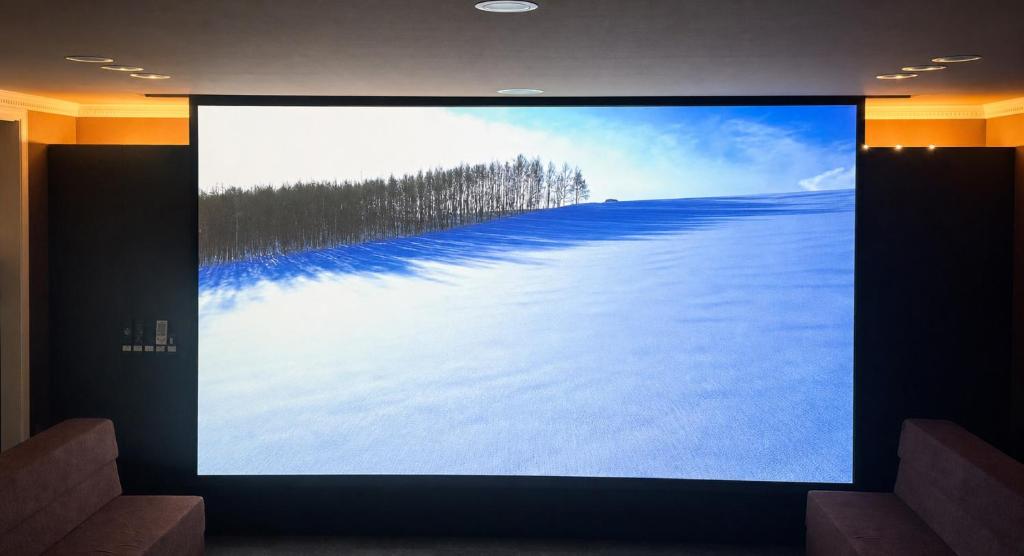 a television screen with a picture of a snow covered field at BIEI TERRACE 1st Floor - 1F専用独立玄関 - 1F占有78平米大型ワンルーム- ソファベッド7台, 170型米Valerion社製最新シアター動画視聴, 無料Wi-Fi, シャワー, ミニキッチン付き - 駅前通り沿い - in Biei