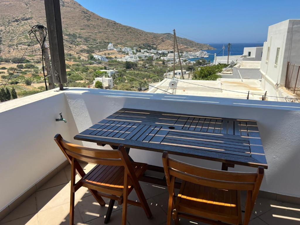 a table and two chairs on a balcony with a view at Ageon Amorgos in Amorgos