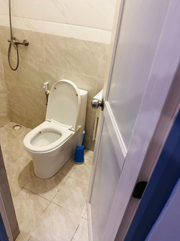 a bathroom with a white toilet in a room at Hiyaa H7 in Hulhumale