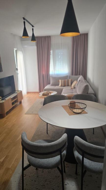 a living room with a table and a couch at Lovely apartmant Bar in Bar