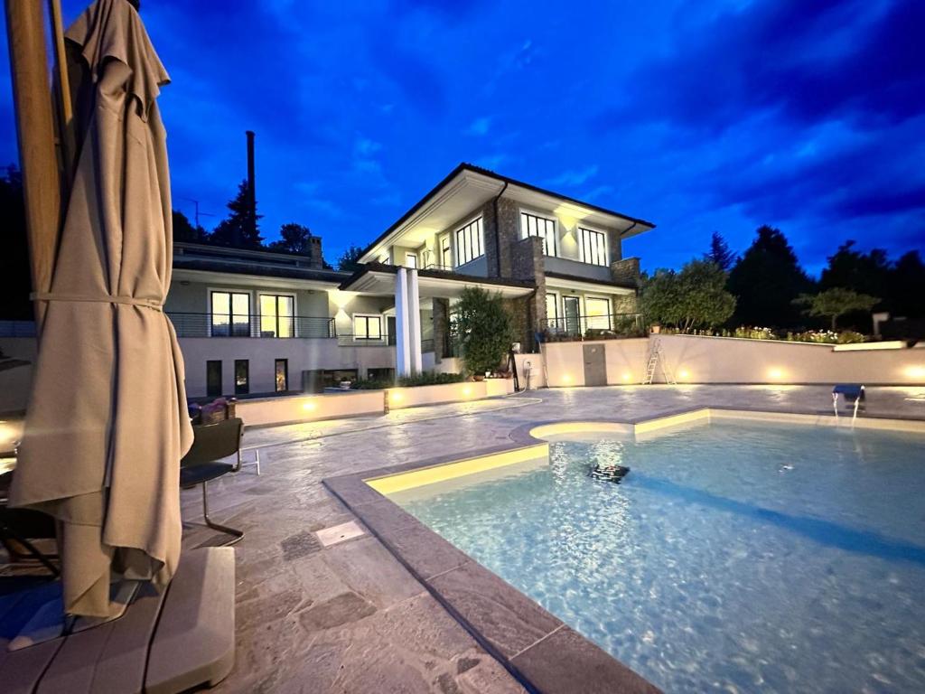 a house with a swimming pool at night at Villa Seli in Dogliani