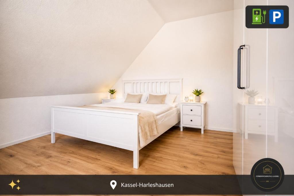 a white bedroom with a bed and two night stands at Ferienwohnung Kassel mit Ladesäule in Kassel