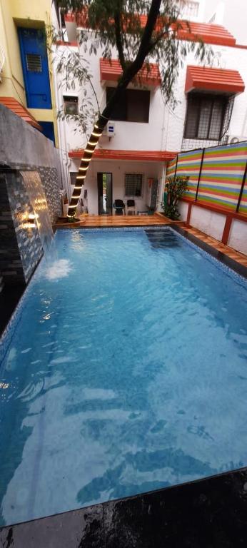 a large swimming pool in front of a building at Yash villa - 2 Bhk ll Private pool ll Wifi ll Tv ll in Lonavala