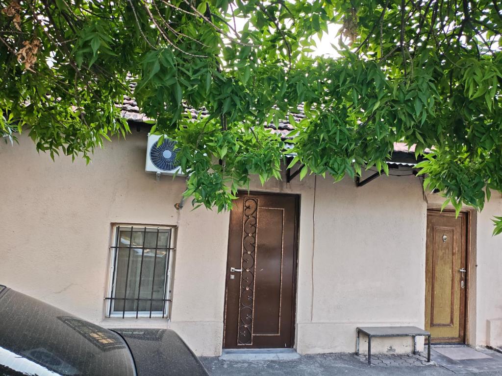 a house with a door and a bench in front of it at Vardan's Guest House in Yerevan