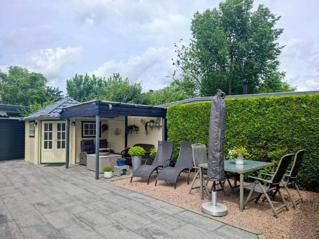 a patio with a table and chairs and a building at CHALET36 in GROU in Grou