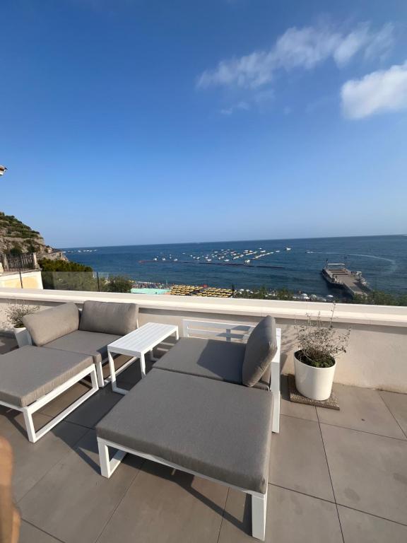 a patio with two couches and a view of the ocean at Marefuori Suite in Minori