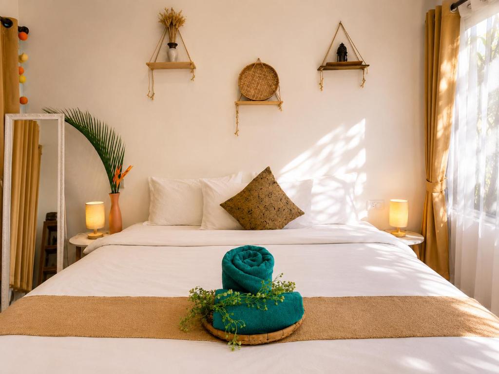 a bedroom with a bed with a blue cake on it at The Verandas in Hinkong