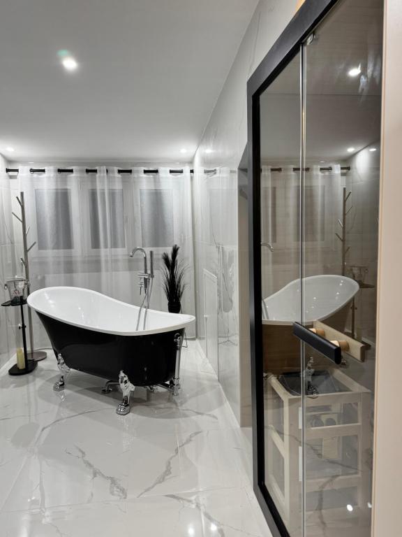a bathroom with a tub and a glass shower at LuxLife - Panorama Bergblick, Sauna, Balkon, Luxus Pur in Buchenberg