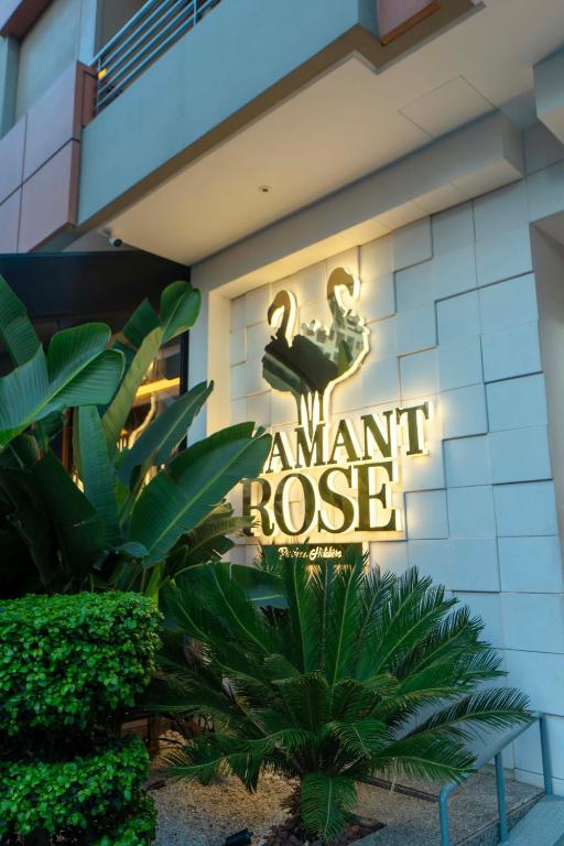 a sign on the side of a building with a flamingo at Flamant Rose Appart Hotel in Tangier