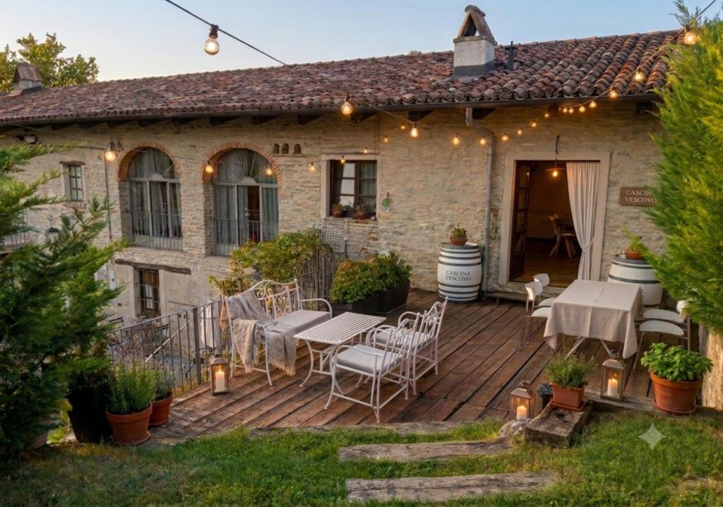 an outdoor patio with tables and chairs on a wooden deck at Cà Tinola in Mango