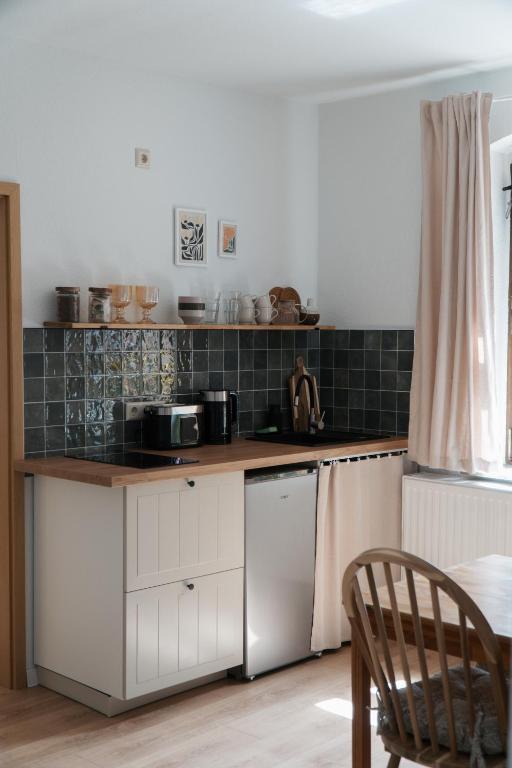 a kitchen with white cabinets and a counter top at "LOKAL" Apartment 1 in Bad Muskau