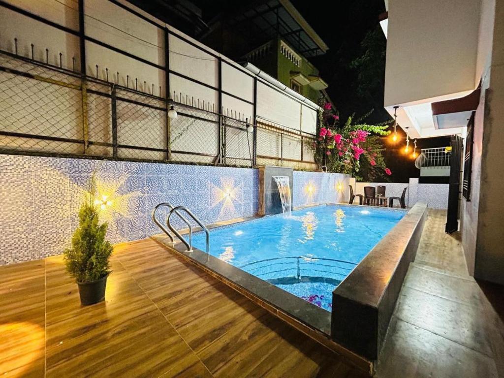 a swimming pool in the middle of a building at Orchid Villa - The Dream Stays ll Big Pvt Pool ll 3Ac room ll Wi-Fi ll Tv in Lonavala