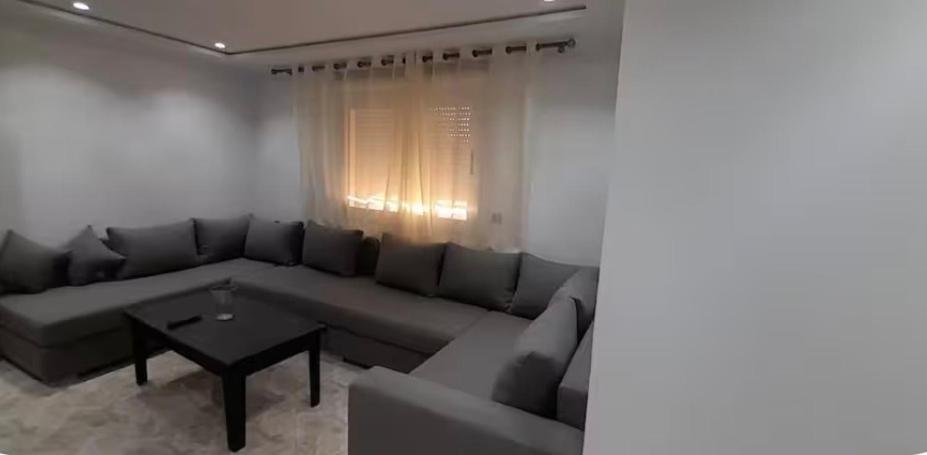 a living room with a couch and a table at Apartamento dina 13 in Fnidek