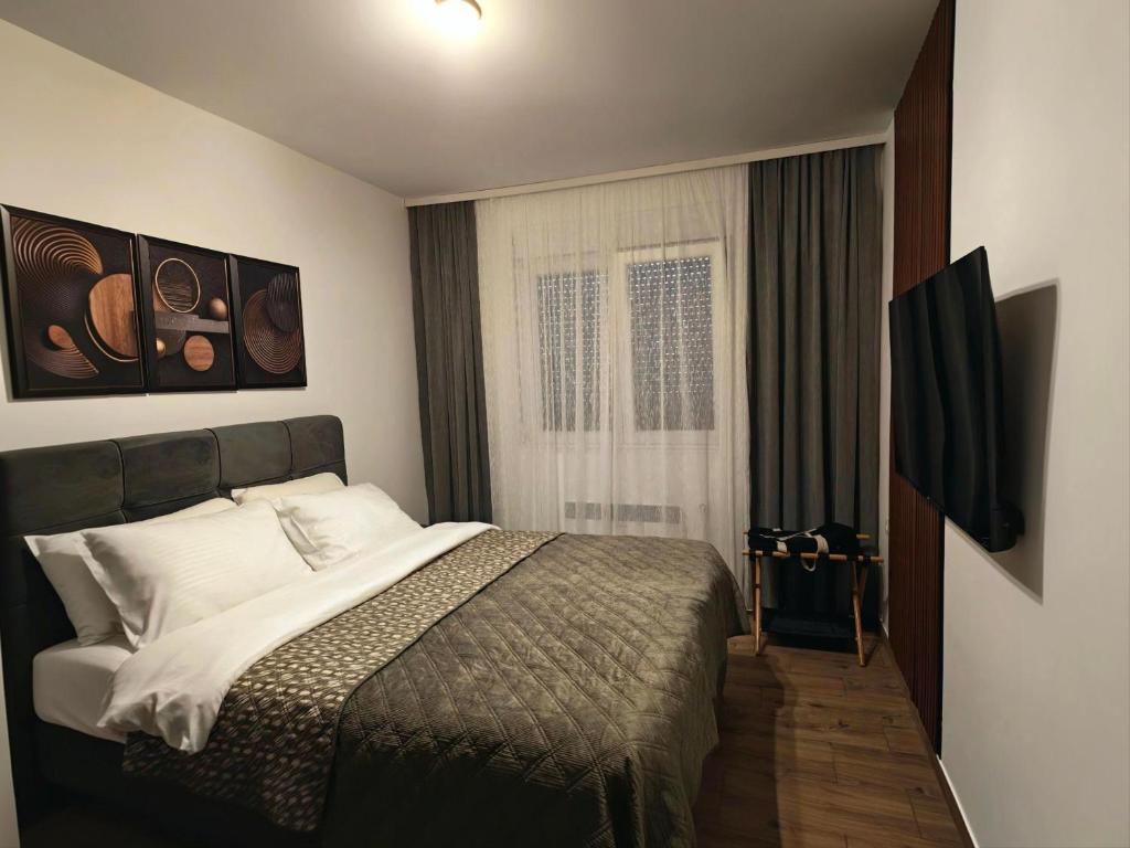 a bedroom with a large bed and a window at KM Lux & SPA in Veliko Gradište