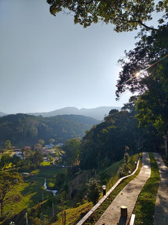 a winding road with a view of a valley at Pousada e Restaurante Casa Cida e Evandro in Gaspar