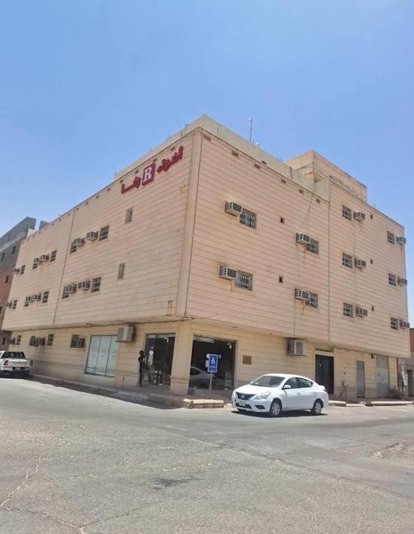 a white car parked in front of a building at شقق اضواء رفا للشقق المخدومة in Al Kharj