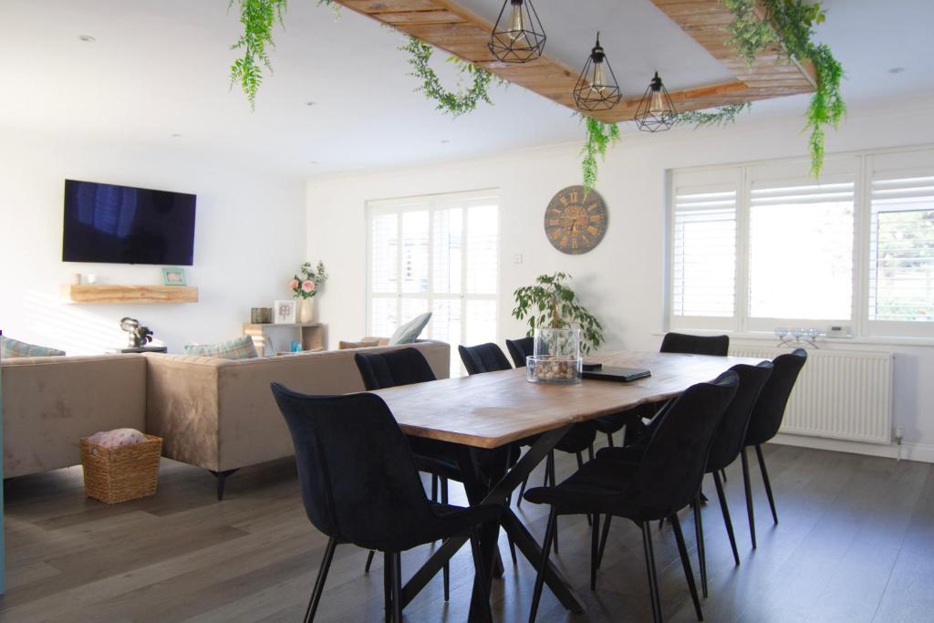 a living room with a wooden table and chairs at Coopers by the Coast in Selsey