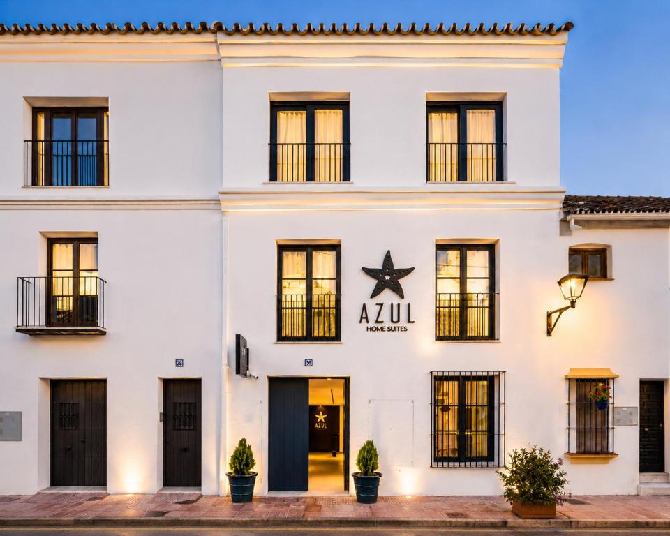a white building with a star sign on it at AZUL HOME SUITES Estepona in Estepona