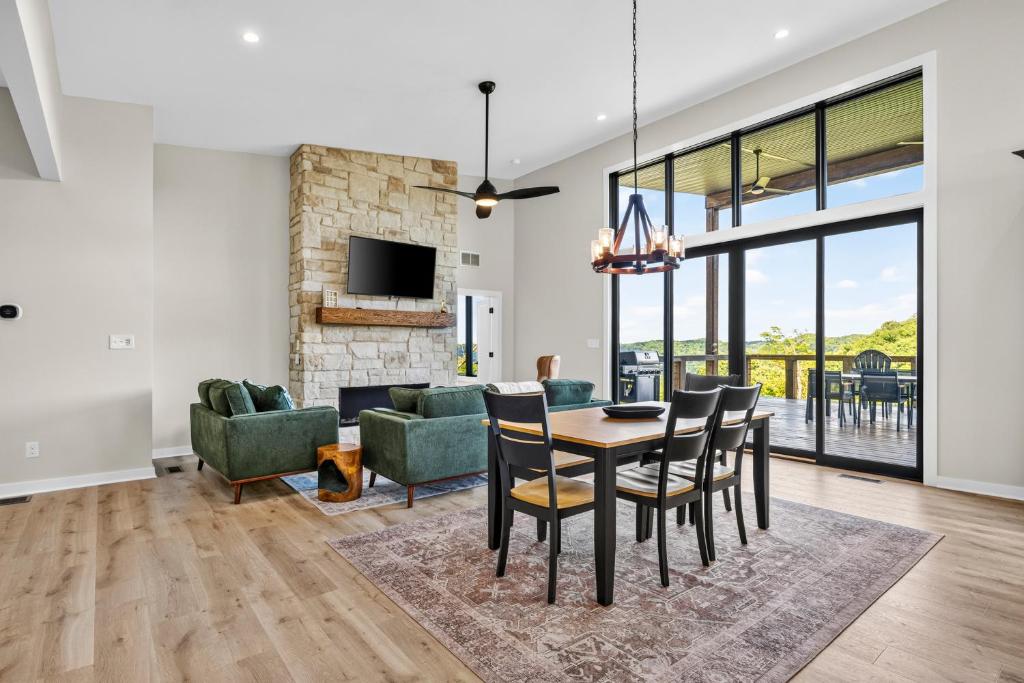 a dining room and living room with a table and chairs at Cambridge Cabin in Stanton