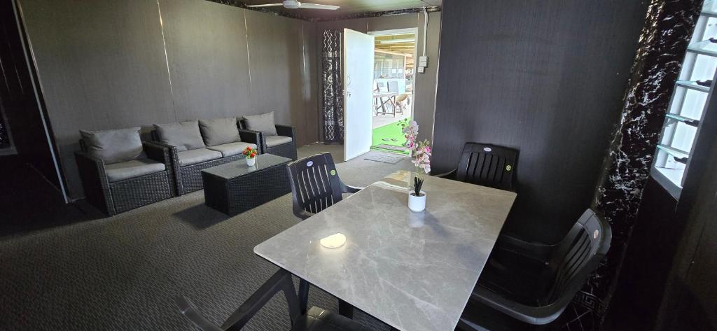 a room with a table and chairs and a couch at Haven Apartments- Nadi in Nadi