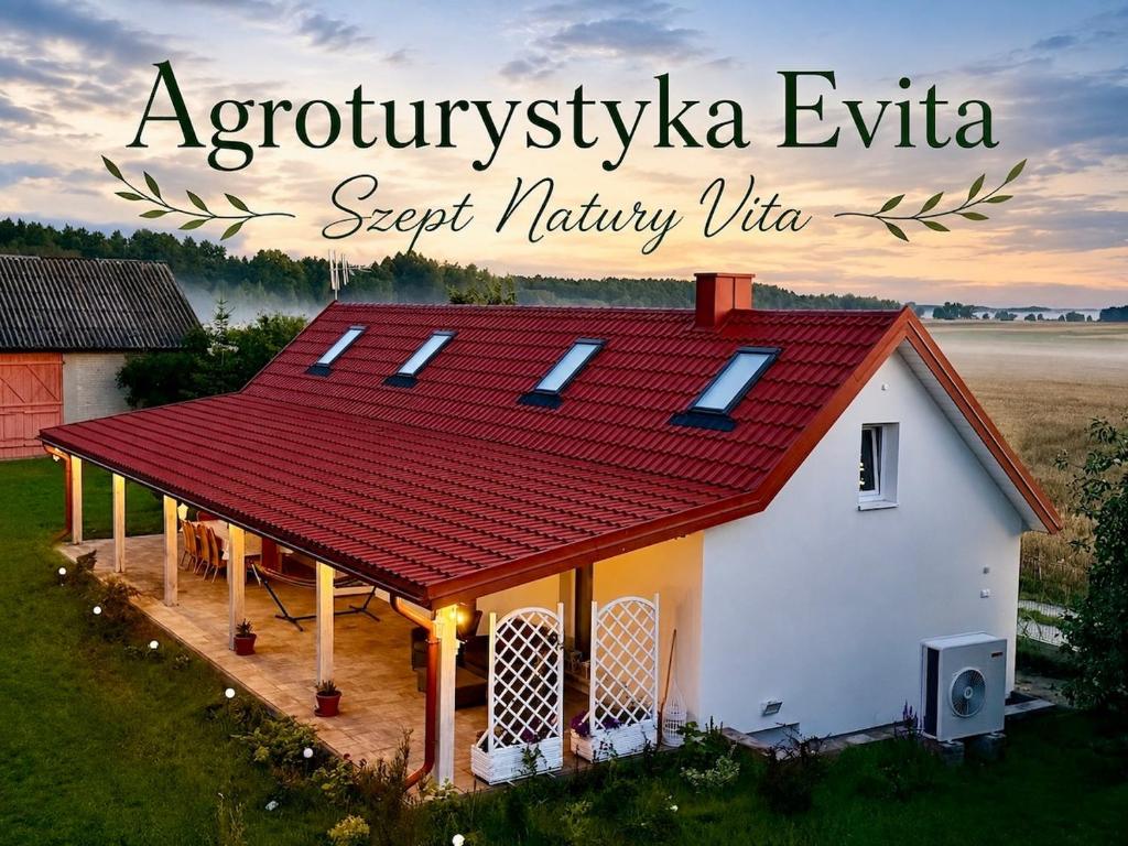 a small white house with a red roof at Agroturystyka Evita in Jabłeczna